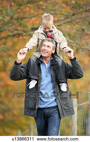 Man With Young Son On Shoulders Autumn Park View Large Photo Image Stock Image - Man With Young Son On Shoulders Autumn Park. Fotosearch