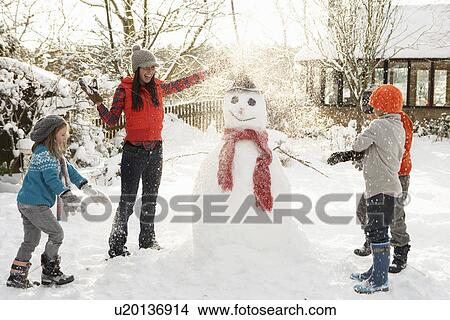 Mother And Children Building Snowman In Garden View Large Photo Image Picture - Mother And Children Building Snowman In Garden. Fotosearch