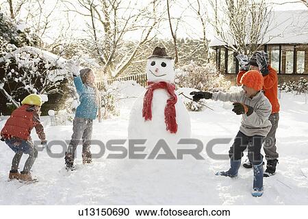 Mother And Children Building Snowman In Garden View Large Photo Image Stock Image - Mother And Children Building Snowman In Garden. Fotosearch