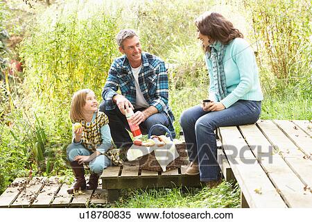 Stock Photography - Parents And Children Having Picnic In Countryside. Fotosearch