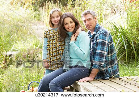 Parents And Daughter Having Picnic In Countryside View Large Photo Image Stock Photo - Parents And Daughter Having Picnic In Countryside. Fotosearch