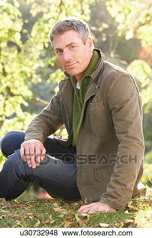 Stock Photo - Portrait Of Man Outdoors In Autumn Landscape. Fotosearch