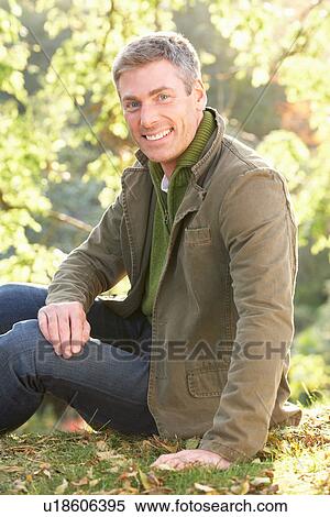 Stock Photography - Portrait Of Man Outdoors In Autumn Landscape. Fotosearch