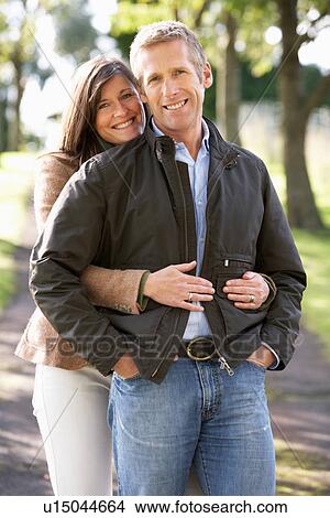 Picture - Portrait Of Romantic Couple Enjoying Outdoor Walk Through Autumn Park. Fotosearch