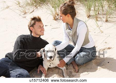 Portrait Of Romantic Teenage Couple On Beach With Dog View Large Photo Image Stock Photograph - Portrait Of Romantic Teenage Couple On Beach With Dog. Fotosearch