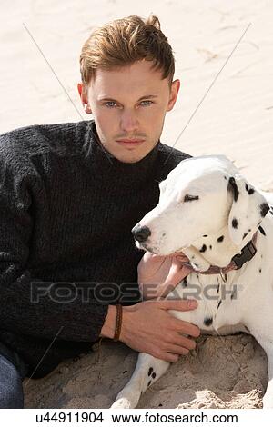 Picture - Portrait Of Teenage Boy On Beach With Dog. Fotosearch