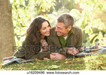 Romantic Couple Relaxing Outdoors In Autumn Landscape View Large Photo Image Stock Photograph - Romantic Couple Relaxing Outdoors In Autumn Landscape. Fotosearch
