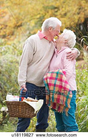 Romantic Senior Couple Outdoors With Picnic Basket By Autumn Woodland View Large Photo Image Stock Photo - Romantic Senior Couple Outdoors With Picnic Basket By Autumn Woodland. Fotosearch