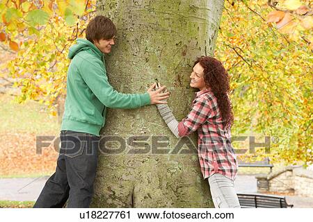 Romantic Teenage Couple By Tree In Autumn Park View Large Photo Image Stock Image - Romantic Teenage Couple By Tree In Autumn Park. Fotosearch