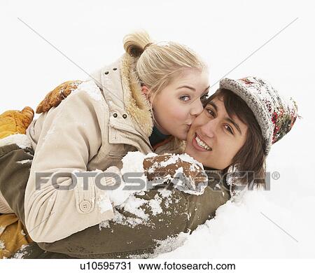 Stock Image - Romantic Teenage Couple Having Fun In Snow. Fotosearch