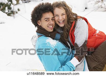Stock Photo - Romantic Teenage Couple Having Fun In Snow. Fotosearch
