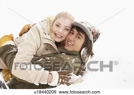 Stock Photo - Romantic Teenage Couple Having Fun In Snow. Fotosearch