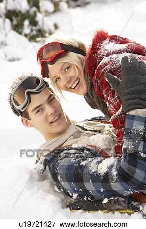 Stock Photo - Romantic Teenage Couple Having Fun In Snow. Fotosearch