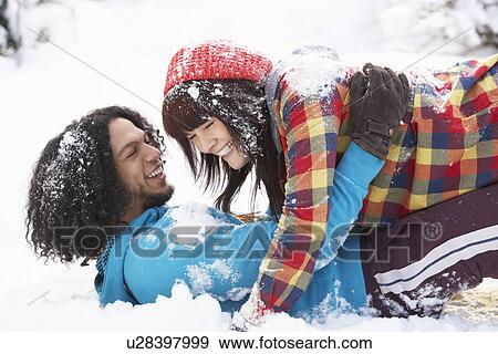 Stock Photo - Romantic Teenage Couple Having Fun In Snow. Fotosearch