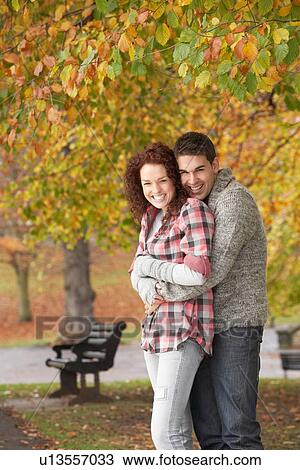 Romantic Teenage Couple In Autumn Park View Large Photo Image Stock Image - Romantic Teenage Couple In Autumn Park. Fotosearch