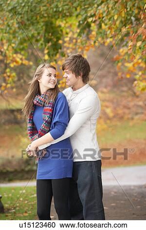 Romantic Teenage Couple In Autumn Park View Large Photo Image Stock Image - Romantic Teenage Couple In Autumn Park. Fotosearch