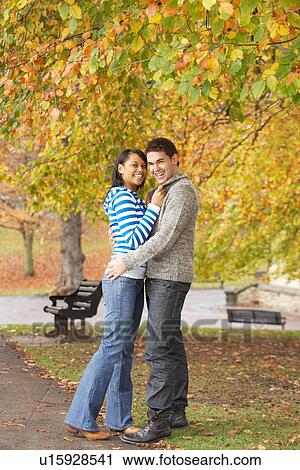 Romantic Teenage Couple In Autumn Park View Large Photo Image Stock Image - Romantic Teenage Couple In Autumn Park. Fotosearch