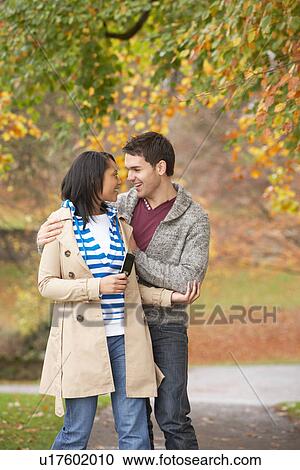 Stock Image - Romantic Teenage Couple In Autumn Park. Fotosearch