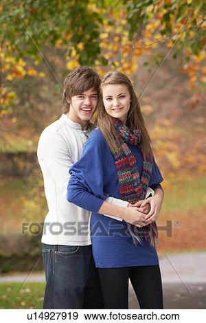 Stock Photo - Romantic Teenage Couple In Autumn Park. Fotosearch