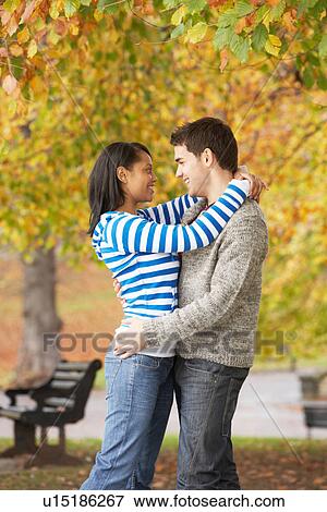 Romantic Teenage Couple In Autumn Park View Large Photo Image Stock Photo - Romantic Teenage Couple In Autumn Park. Fotosearch