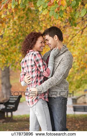 Stock Photograph - Romantic Teenage Couple In Autumn Park. Fotosearch