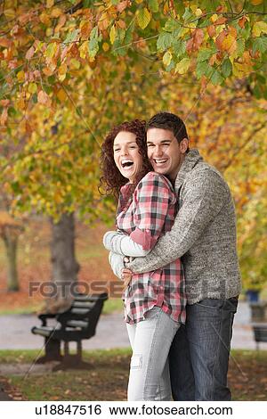 Romantic Teenage Couple In Autumn Park View Large Photo Image Stock Photograph - Romantic Teenage Couple In Autumn Park. Fotosearch