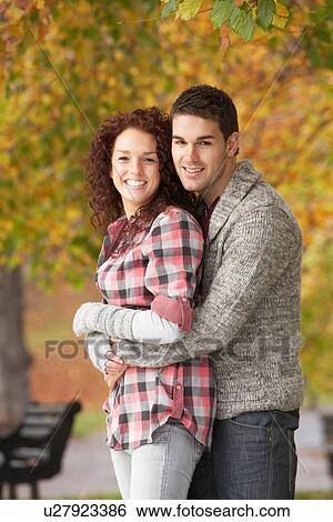 Stock Photograph - Romantic Teenage Couple In Autumn Park. Fotosearch