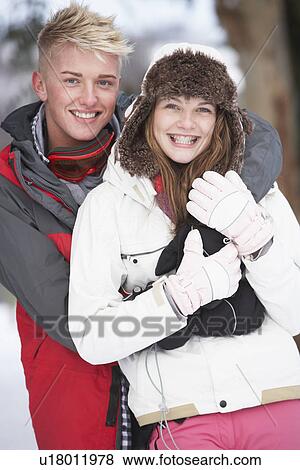 Stock Photo - Romantic Teenage Couple In Snow. Fotosearch