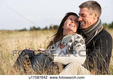 Stock Image - Romantic Young Couple In Autumn Landscape. Fotosearch