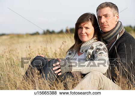 Stock Photo - Romantic Young Couple In Autumn Landscape. Fotosearch
