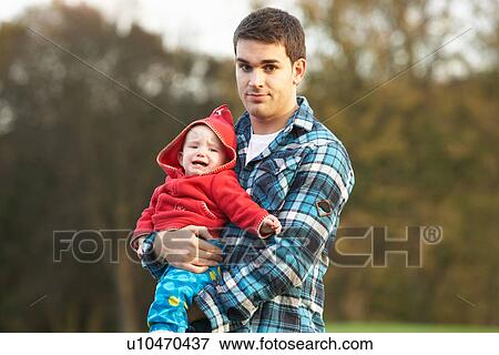 Shocked Teenage Boy Holding Baby View Large Photo Image Stock Photo - Shocked Teenage Boy Holding Baby. Fotosearch