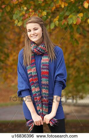 Smiling Teenage Girl Standing In Autumn Park View Large Photo Image Stock Photograph - Smiling Teenage Girl Standing In Autumn Park. Fotosearch