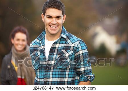 Teenage Boy Outside With Girlfriend In Background View Large Photo Image Stock Photo - Teenage Boy Outside With Girlfriend In Background. Fotosearch