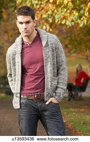 Teenage Boy Standing In Autumn Park With Female Figure On Bench In Background View Large Photo Image Stock Photograph - Teenage Boy Standing In Autumn Park With Female Figure On Bench In Background. Fotosearch