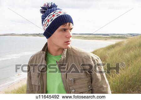 Teenage Boy Standing In Sand Dunes Wearing Woolly Hat View Large Photo Image Stock Image - Teenage Boy Standing In Sand Dunes Wearing Woolly Hat. Fotosearch