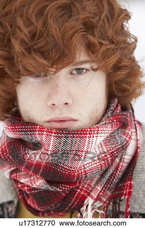 Stock Image - Teenage Boy Wearing Winter Clothes In Snowy Landscape. Fotosearch