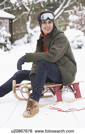 Teenage Boy With Sledge Next To Snowman View Large Photo Image Stock Photo - Teenage Boy With Sledge Next To Snowman. Fotosearch