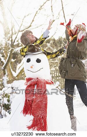 Teenage Couple Building Snowman View Large Photo Image Stock Image - Teenage Couple Building Snowman. Fotosearch