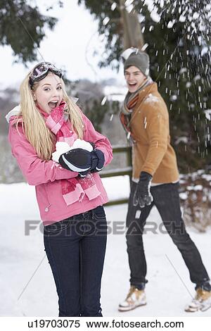 Teenage Couple Having Snowball Fight In Snowy Landscape View Large Photo Image Stock Photography - Teenage Couple Having Snowball Fight In Snowy Landscape. Fotosearch