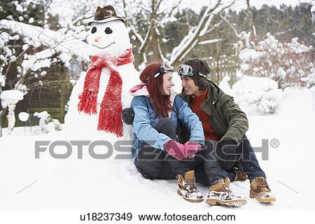Teenage Couple In Winter Landscape Next To Snowman With Flask And Hot Drink View Large Photo Image Stock Photo - Teenage Couple In Winter Landscape Next To Snowman With Flask And Hot Drink. Fotosearch