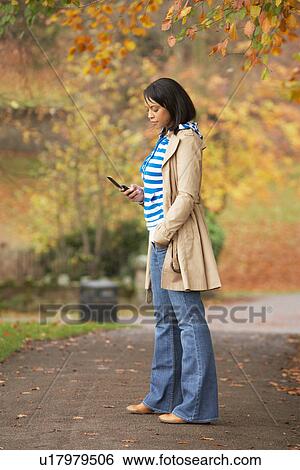Teenage Girl Making Mobile Phone Call In Autumn Landscape View Large Photo Image Stock Photograph - Teenage Girl Making Mobile Phone Call In Autumn Landscape. Fotosearch