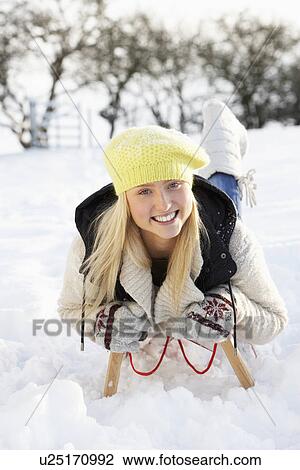Teenage Girl Riding On Sledge In Snowy Landscape View Large Photo Image Stock Image - Teenage Girl Riding On Sledge In Snowy Landscape. Fotosearch