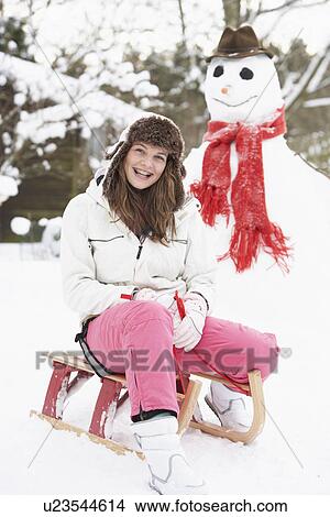 Teenage Girl With Sledge Next To Snowman View Large Photo Image Picture - Teenage Girl With Sledge Next To Snowman. Fotosearch