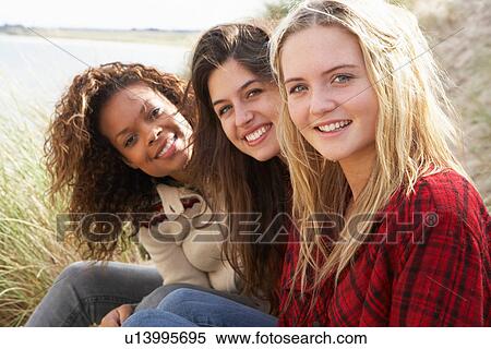 Three Teenage Girls Sitting In Sand Dunes Together View Large Photo Image Stock Photography - Three Teenage Girls Sitting In Sand Dunes Together. Fotosearch