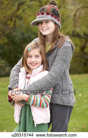 Picture - Two Sisters On Walk In Autumn Countryside. Fotosearch