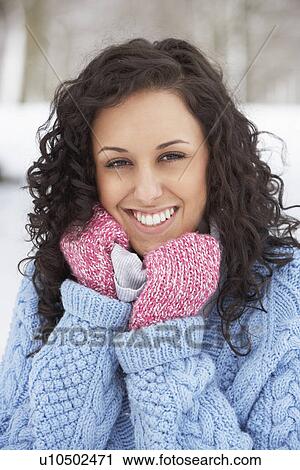 Stock Image - Woman In Snowy Landscape Wearing Warm Clothing. Fotosearch