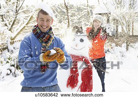 Young Couple Having Snowball Fight In Garden View Large Photo Image Stock Image - Young Couple Having Snowball Fight In Garden. Fotosearch