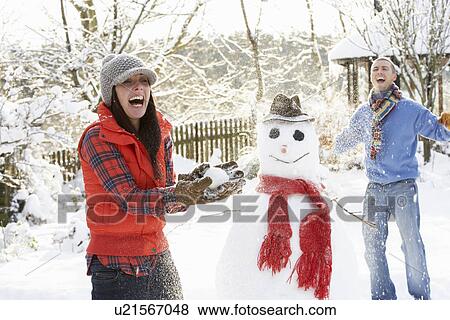 Young Couple Having Snowball Fight In Garden View Large Photo Image Stock Photo - Young Couple Having Snowball Fight In Garden. Fotosearch