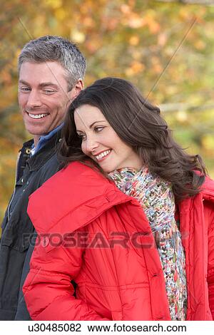 Young Couple Walking Through Autumn Park View Large Photo Image Stock Image - Young Couple Walking Through Autumn Park. Fotosearch