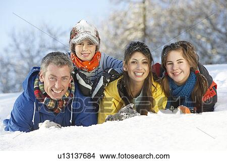 Picture - Young Family Having Fun In Snowy Landscape. Fotosearch